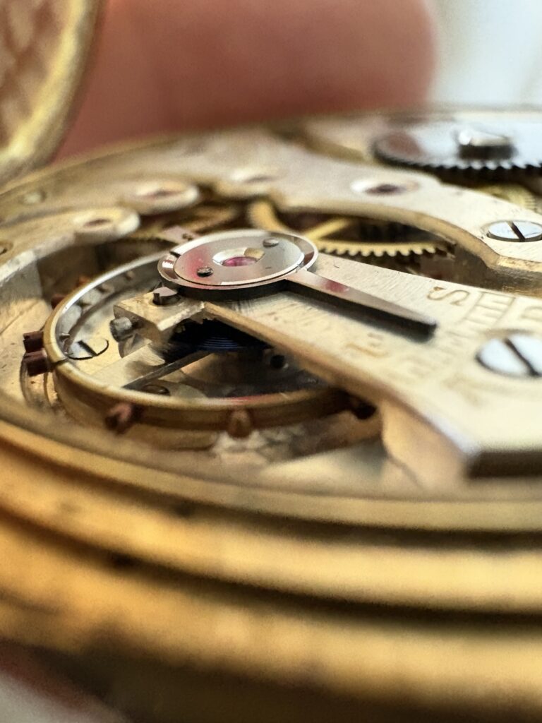 Vintage gold pocket watch internals held in hand, purchased 1926